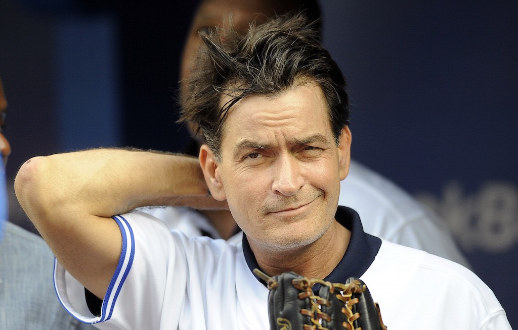 Charlie Sheen smiles during a filming.