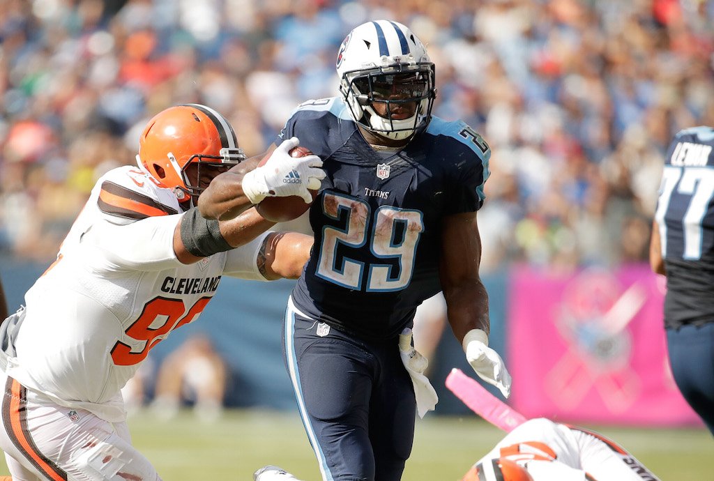 Demarco Murray running with the ball in his hands, fighting off defenders