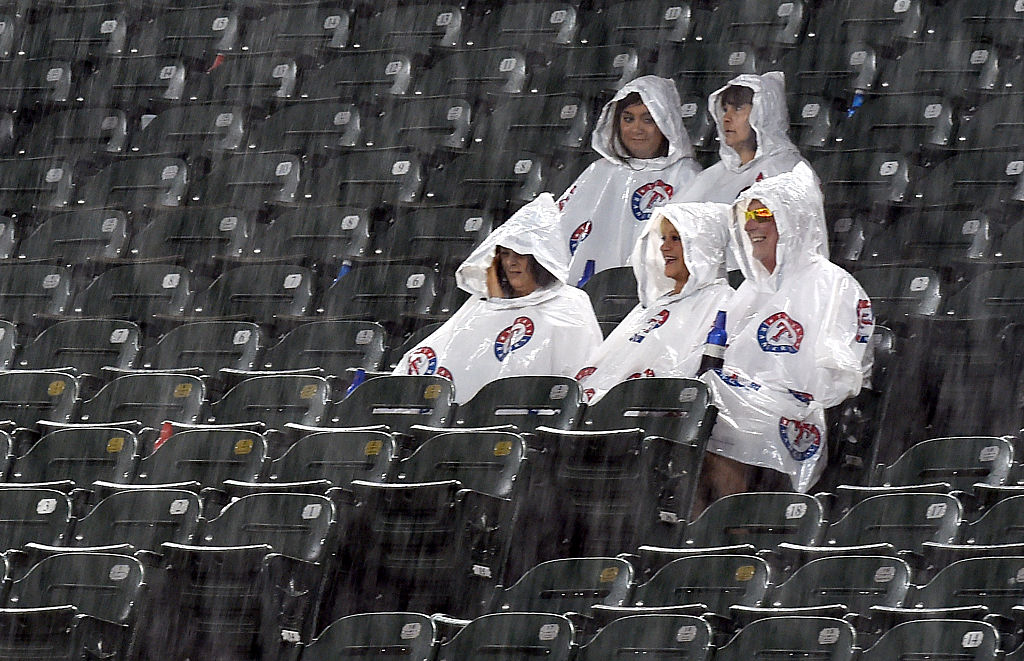 Fans wait in the stands as thunderstorms delay performances at ACM Presents: Superstar Duets at Globe Life Park in Arlington on April 17, 2015 in Arlington, Texas. | Ethan Miller/Getty Images
