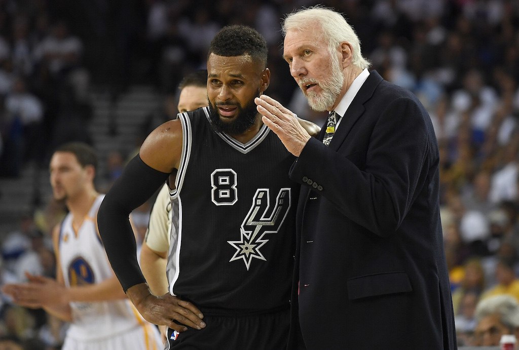 Gregg Popovich provides some wisdom to a player during a game