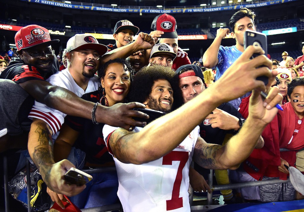 Colin Kaepernick poses for photos with fans.