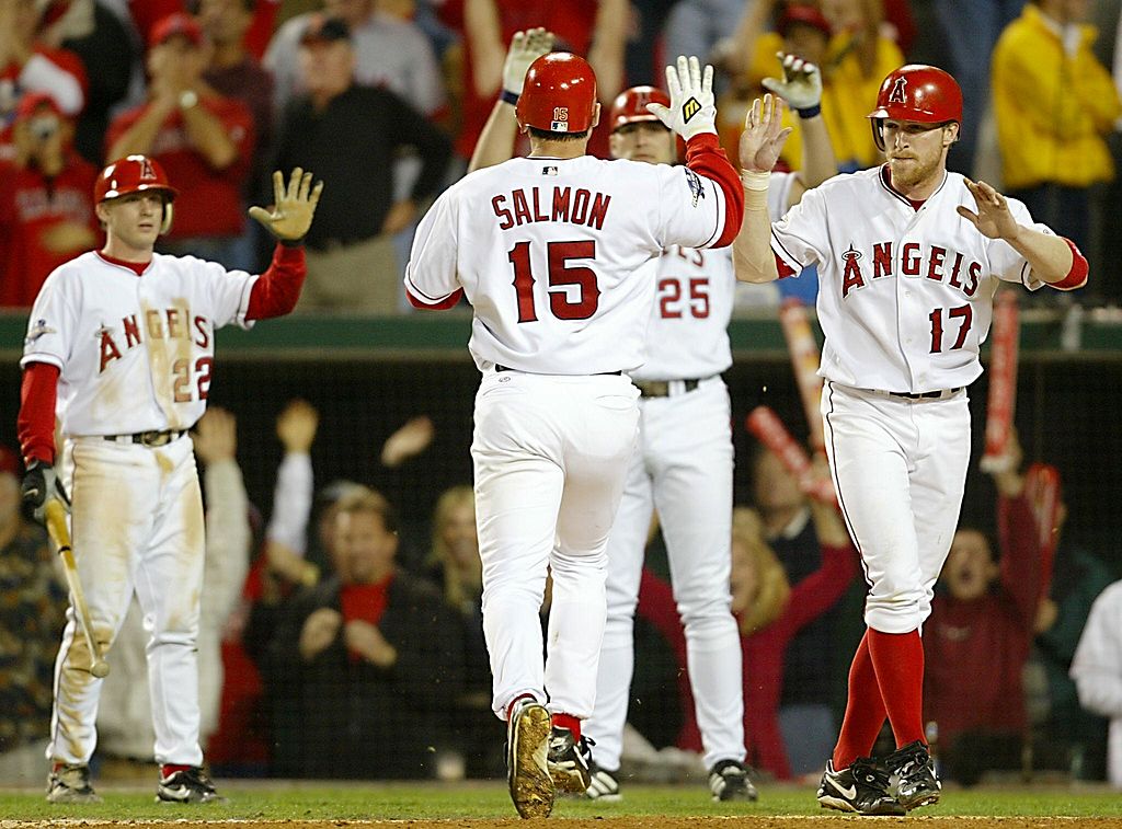 Anaheim Angels Tim Salmon (15) is congratulated as he crosses home plate