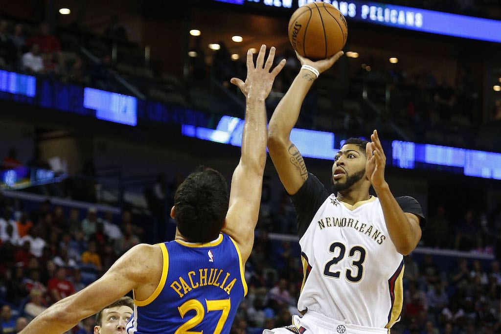 Anthony Davis of the New Orleans pelicans sails over Zaza pachulia, formerly of the Golden State Warriors.
