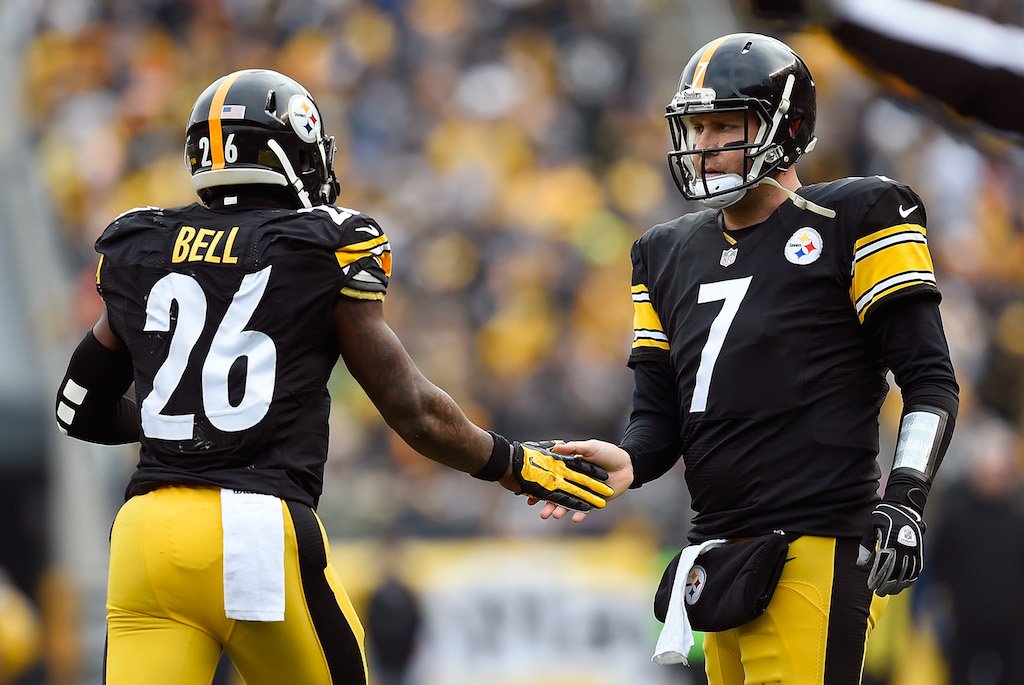 LeVeon Bell and Big Ben give each other a low five.