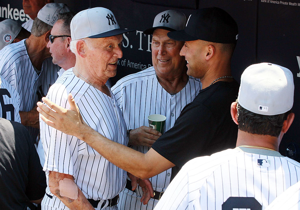 Derek Jeter #2 of the New York Yankees talks with former Yankee Don Larsen