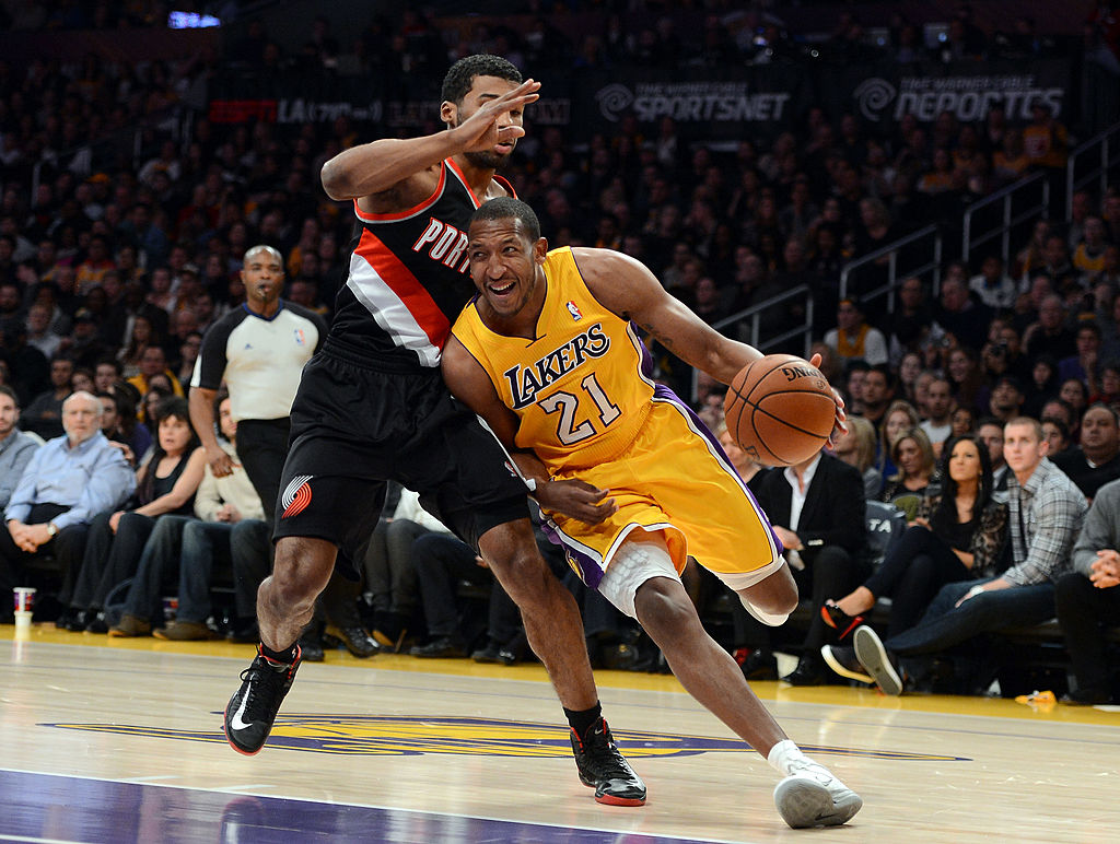 Chris Duhon of the Los Angeles Lakers drives around Ronnie Price of the Portland Trail Blazers.