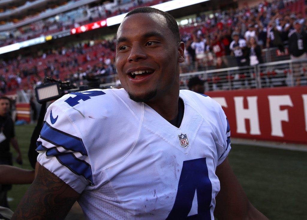 Dak Prescott smiles as he walks off the field after a win.