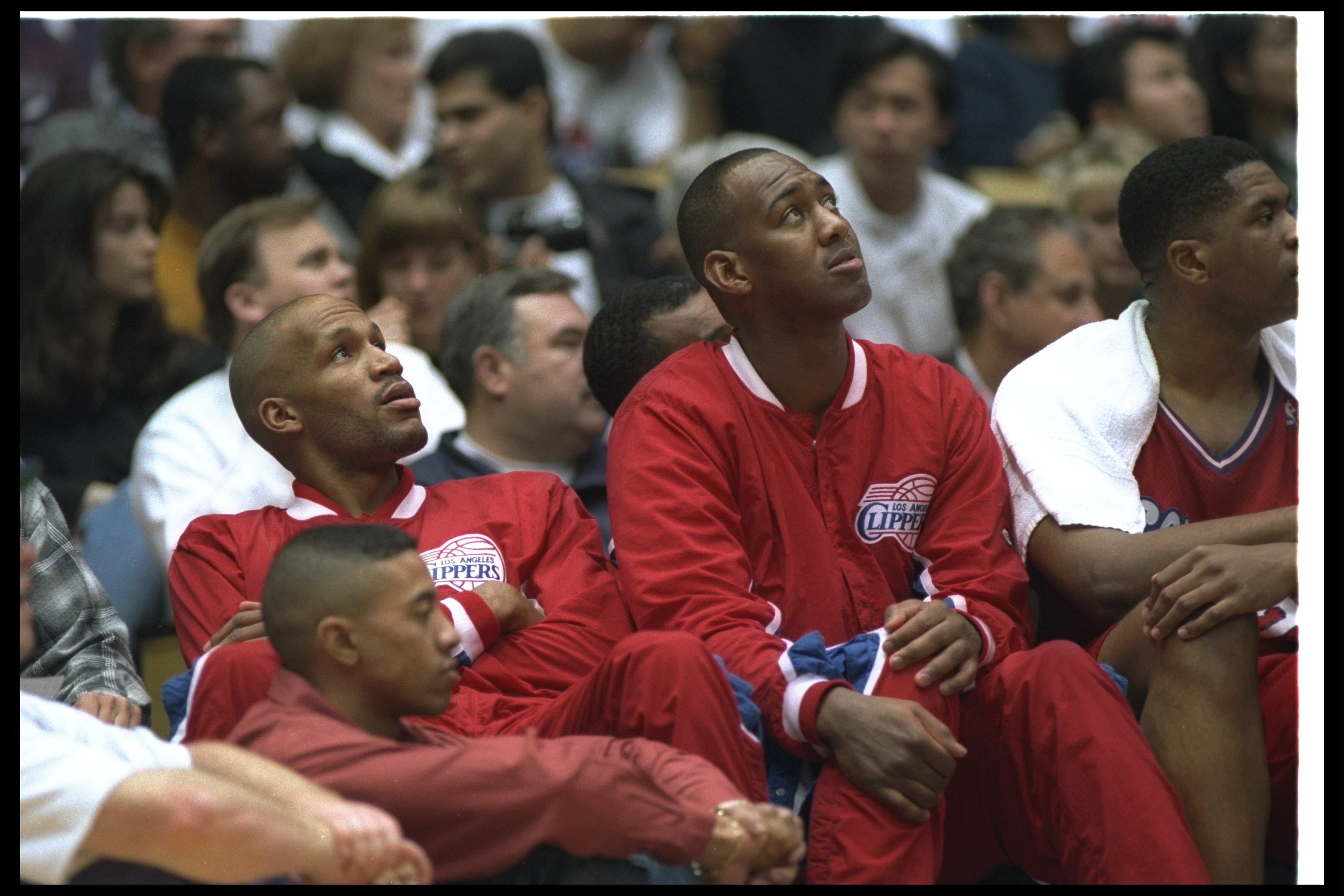 Danny Manning of the Los Angeles Clippers and teammate Ron Harper look on during a game against the Los Angeles Lakers at the Great Western Forum in Inglewood, California. The Clippers won the game, 100-89. Mandatory Credit: J. D. Cuban /Al