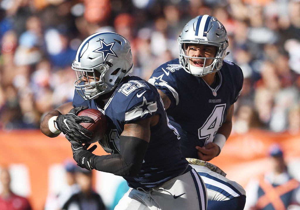 Dak Prescott hands the ball off to Ezekiel Elliott.