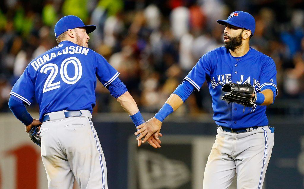Josh Donaldson and Edwin Encarnacion low five.
