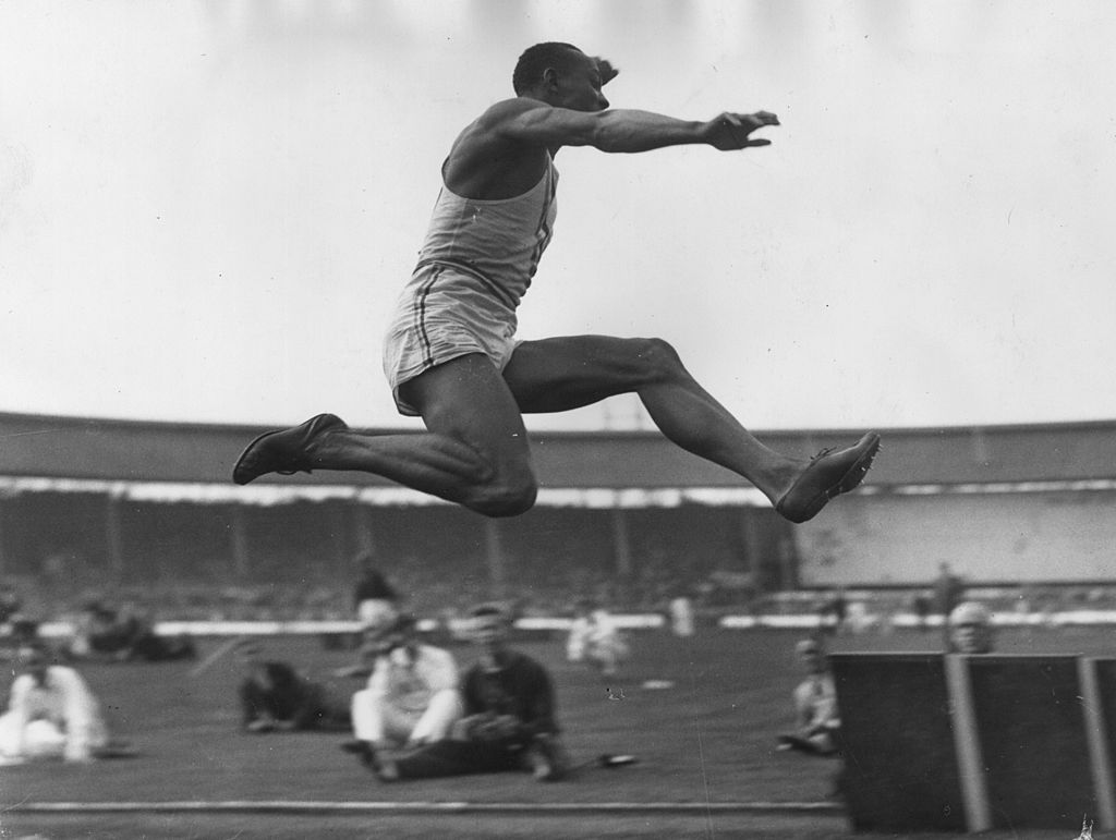 American athlete, Jesse Owens takes part in the long jump event in a USA versus British Empire