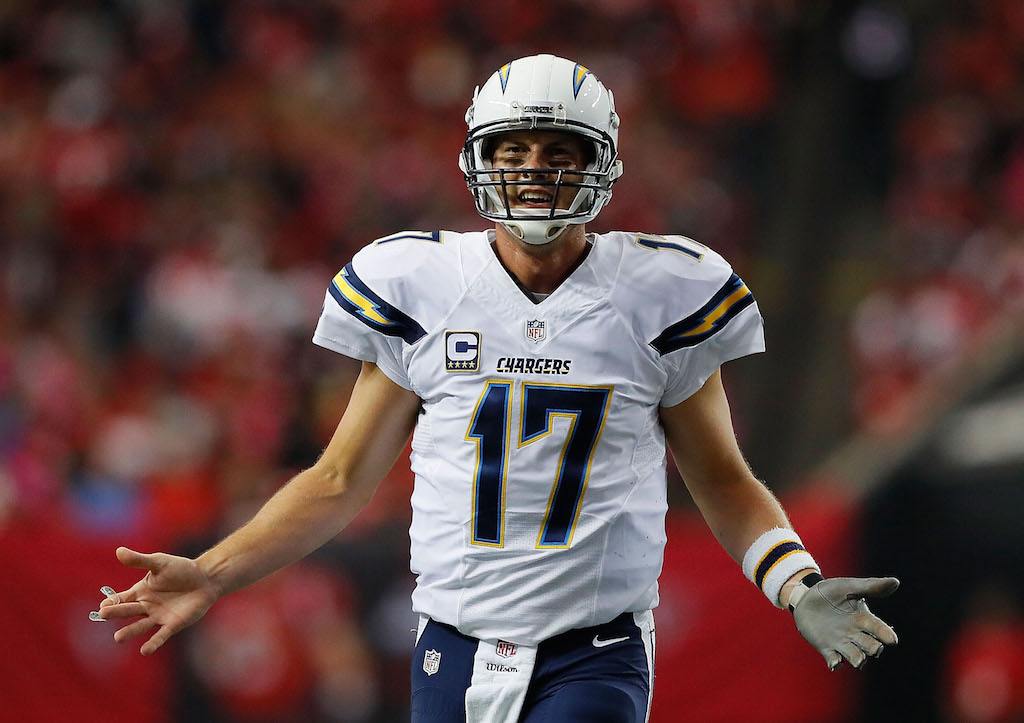 Philip Rivers talks to his coaching staff during a game in 2016.