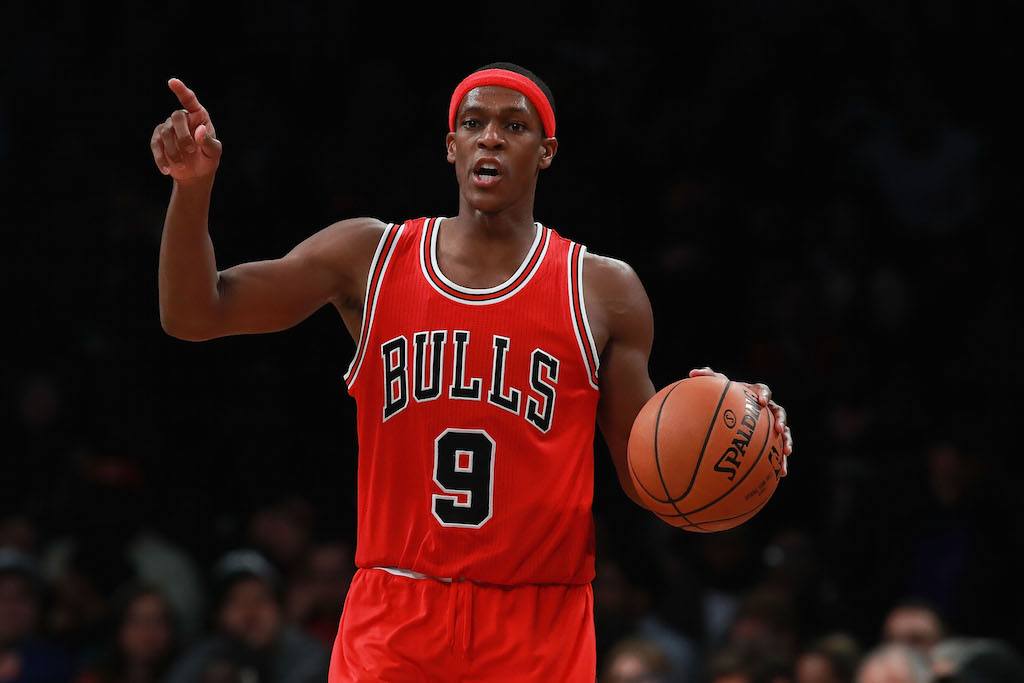 Rajon Rondo wearing a Chicago Bulls uniform and holding a basketball.