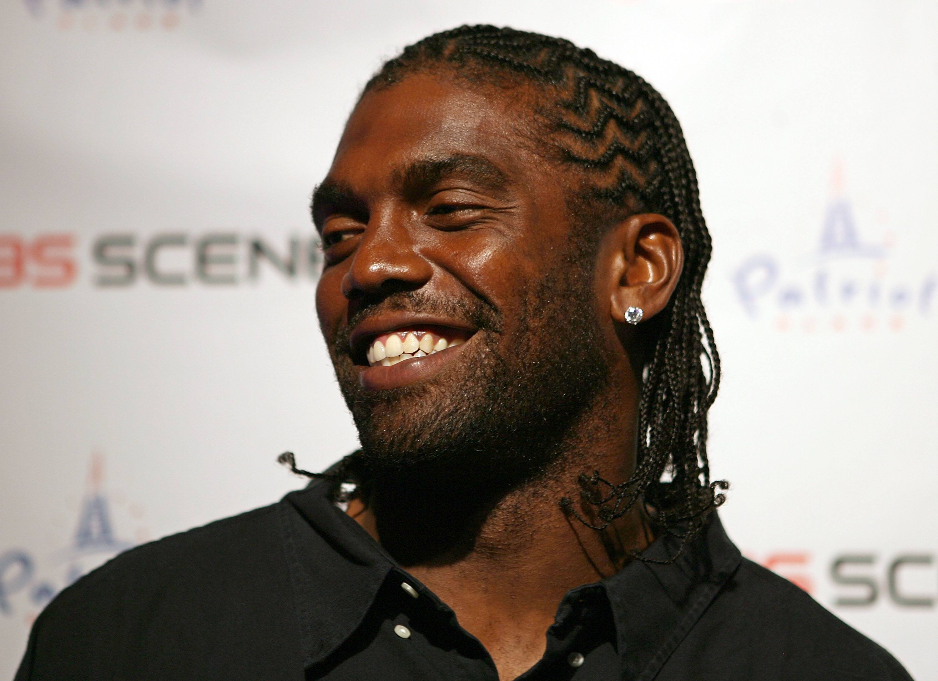 Randy Moss smiles during a media conference.
