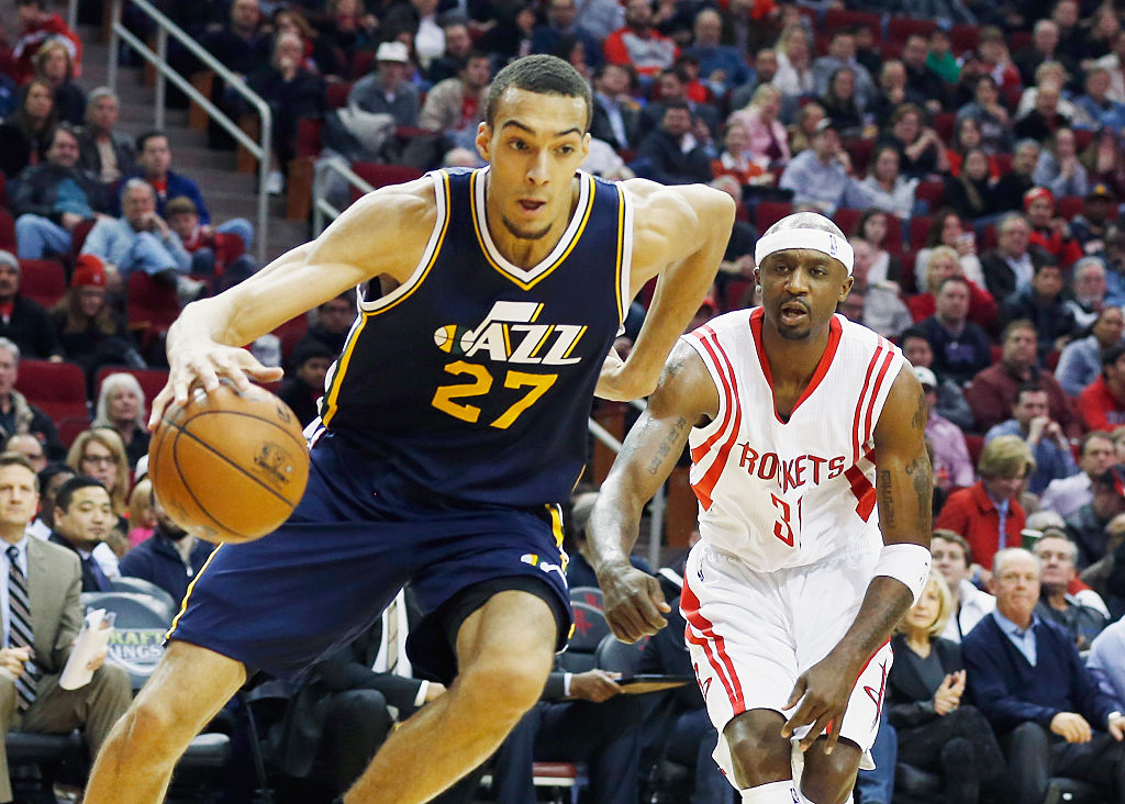 Rudy Gobert of the Utah Jazz drives with the basketball in front of Jason Terry of the Houston Rockets