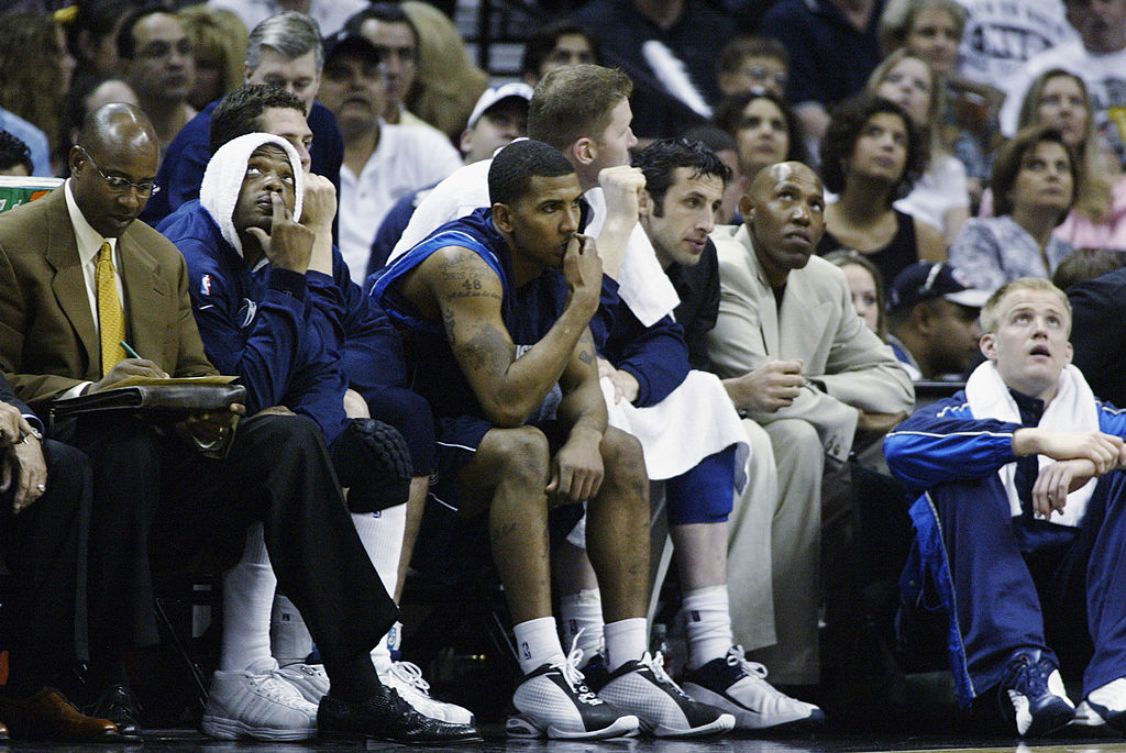 Assistant coach Sidney Moncrief (L) of the Dallas Mavericks takes notes.