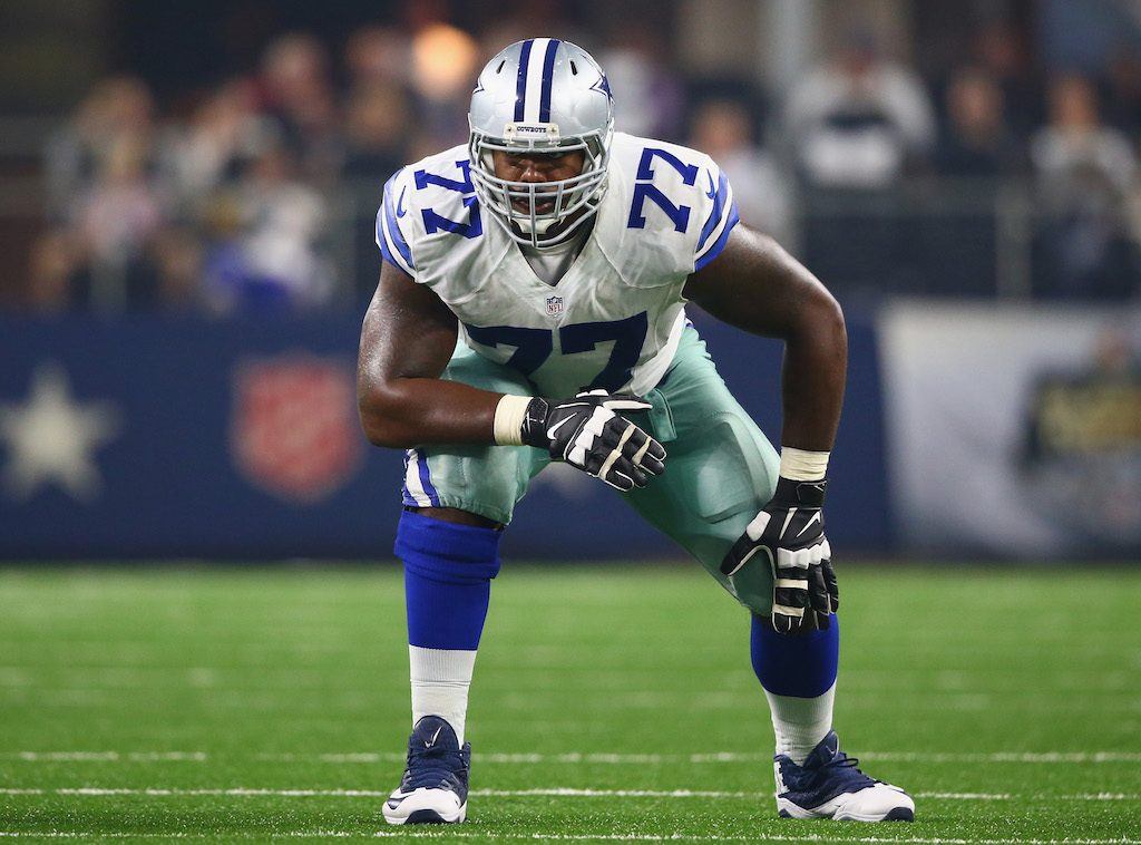 Tyron Smith gets into his stance before a play.