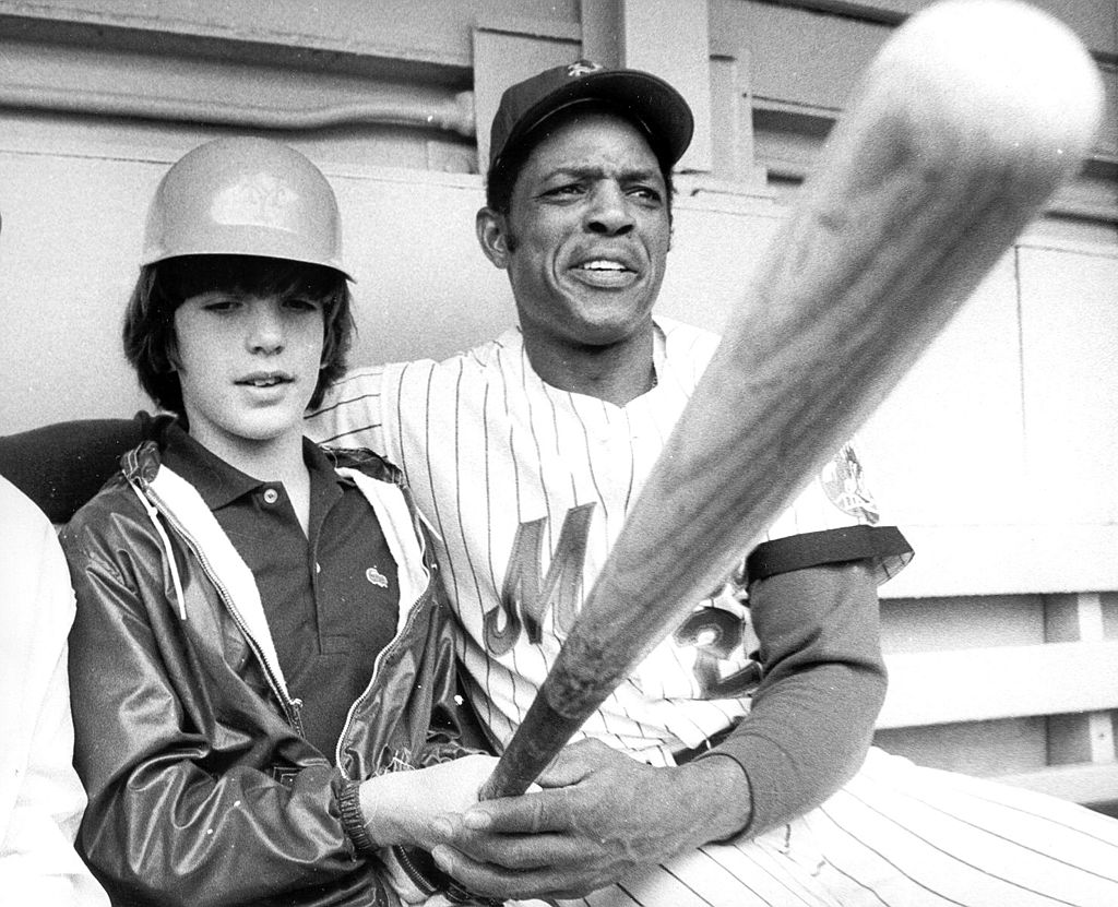 John F. Kennedy Jr (L) is seen with Mets baseball player Willie Mays at Shea Stadium in New York