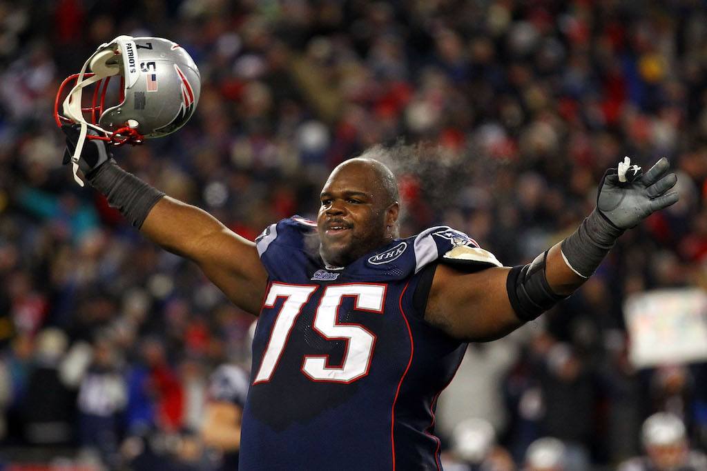 Vince Wilfork holds his arms in the air and pumps up the crowd.