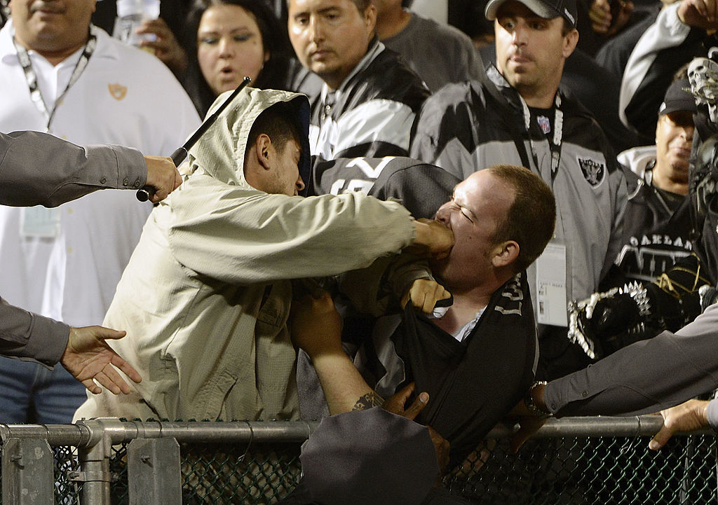 Two fans fight during a game between the San Diego Chargers and Oakland Raiders | Thearon W. Henderson/Getty Images