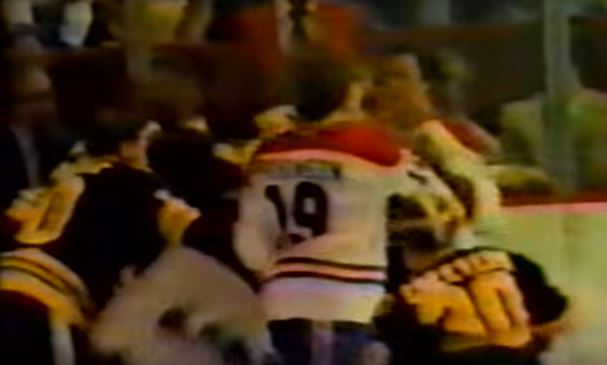 Several members of opposing hockey teams fighting during a game