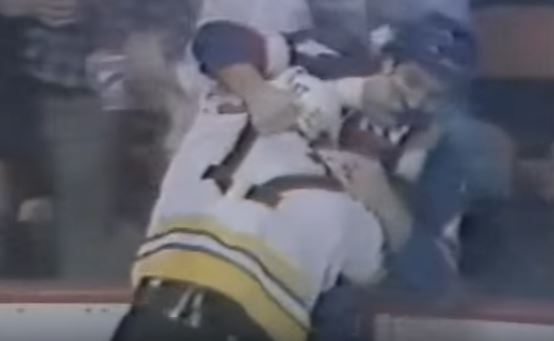 Two members from the Boston Bruins and New York Islanders fighting during a game