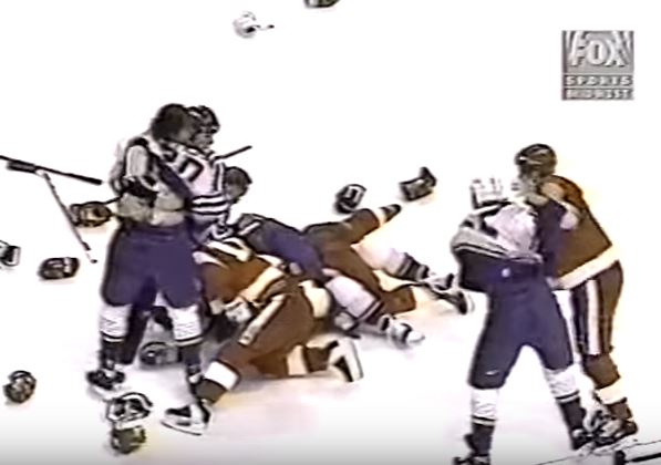 Members of the 1997 Detroit Red Wings and St. Louis Blues fight on the ice.