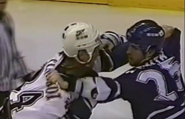 Mark Tinordi and Jason Smith fighting on the ice in 1998