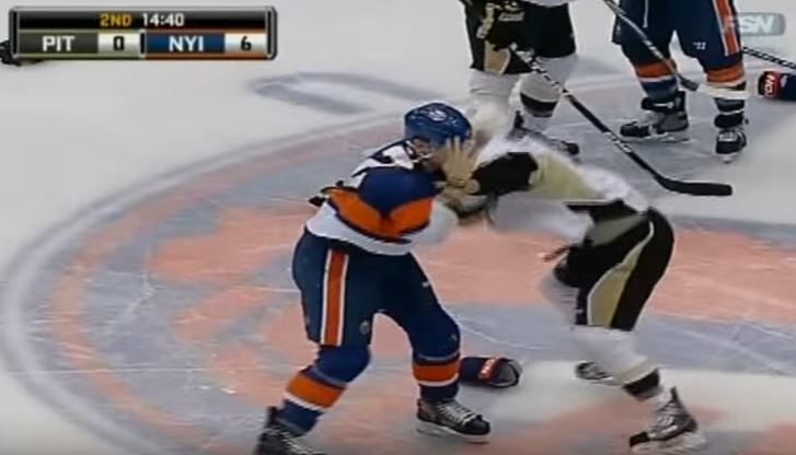 Hockey players from opposing teams fighting during a game