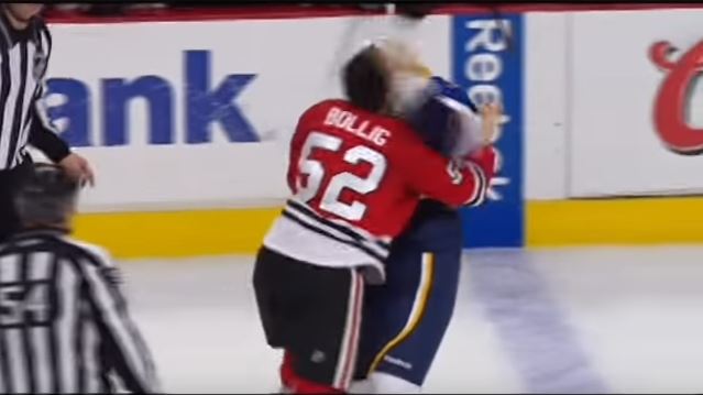 Brandon Bollig of the Blackhawks fighting with an opposing team member