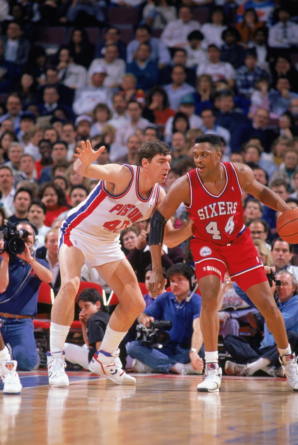 Rick Mahorn of the Philadelphia 76ers is defended by Bill Laimbeer of the Detroit Pistons