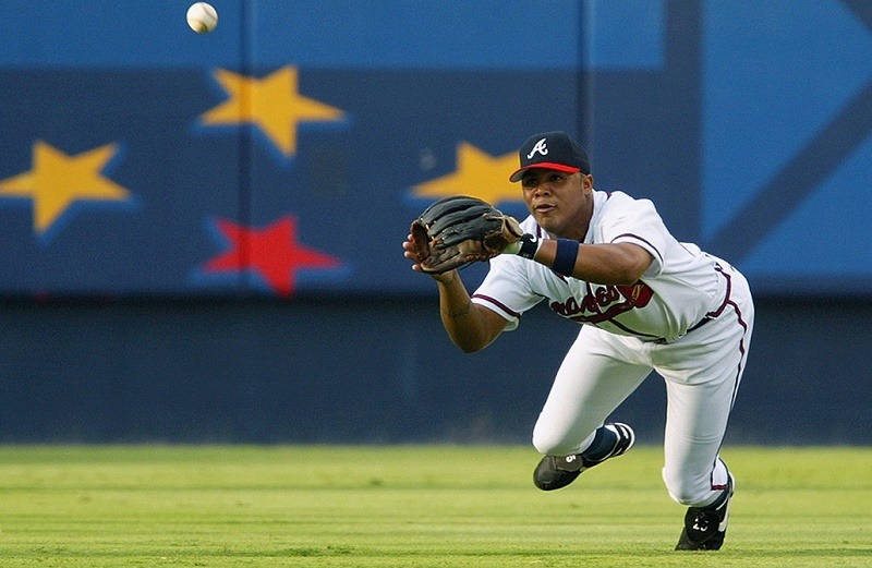 ATLANTA - JULY 31: Centerfielder Andruw Jones #25 of the Atlanta Braves dives for a ball during the MLB game against the Milwaukee Brewers at Turner Field on July 31, 2002 in Atlanta, Georgia.