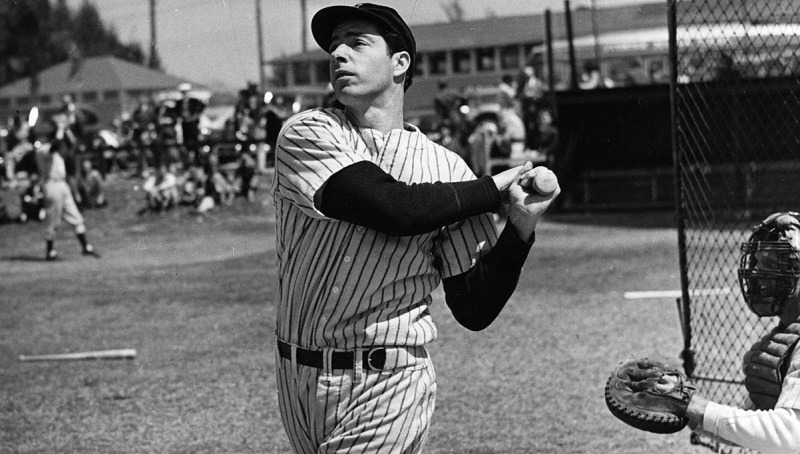 American baseball player Joe DiMaggio (1914 - 1999) hits a belter, circa 1948.