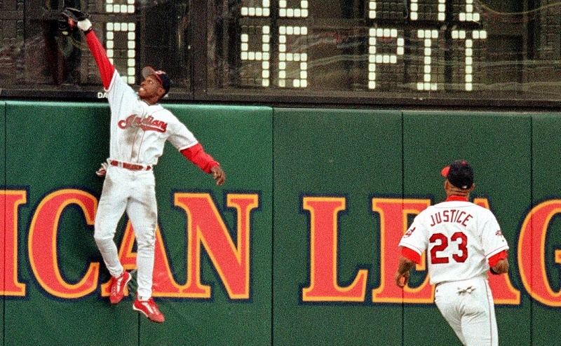 Cleveland Indians center fielder Kenny Lofton makes a leaping catch at the wall to put out Minnesota Twins second baseman Todd Walker.