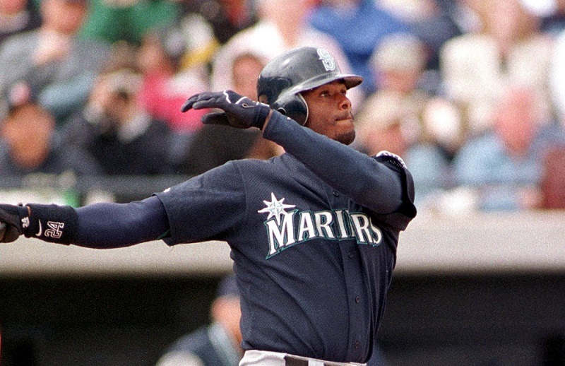 PEORIA, : Seattle Mariners' slugger Ken Griffey Jr., and San Diego Padres catcher Jim Leyritz watch the ball sail deep into center field for a solo home-run against Padres' pitcher Stan Spencer 07 March during Cactus League play in Peoria, Arizona.