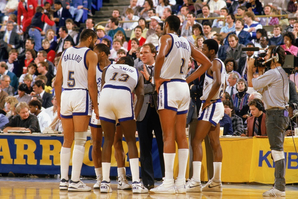 Members of the Golden State Warriors huddle with the coach.