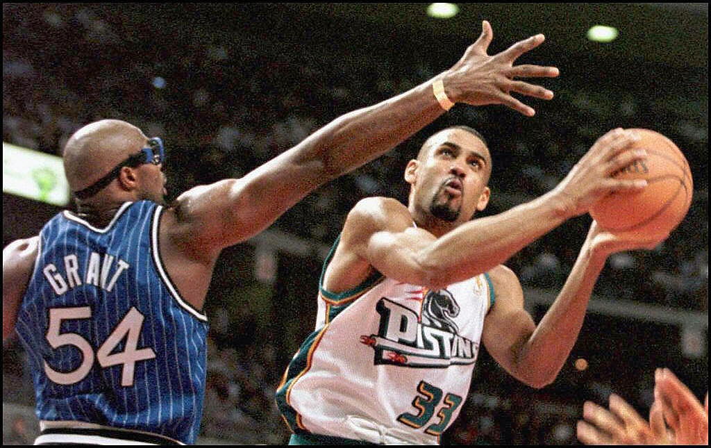 The Detroit Pistons' Grant Hill drives past the Orlando Magic's Horace Grant.