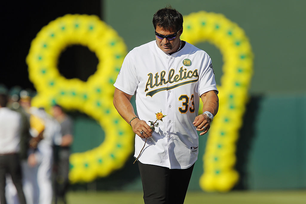 Jose Canseco carried a yellow rose while wearing an Oakland A's jersey