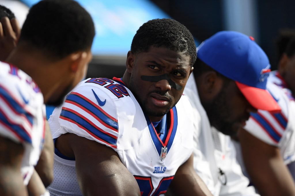 Reggie Bush sits on the bench while he talks to a teammate | Thearon W. Henderson/Getty Images