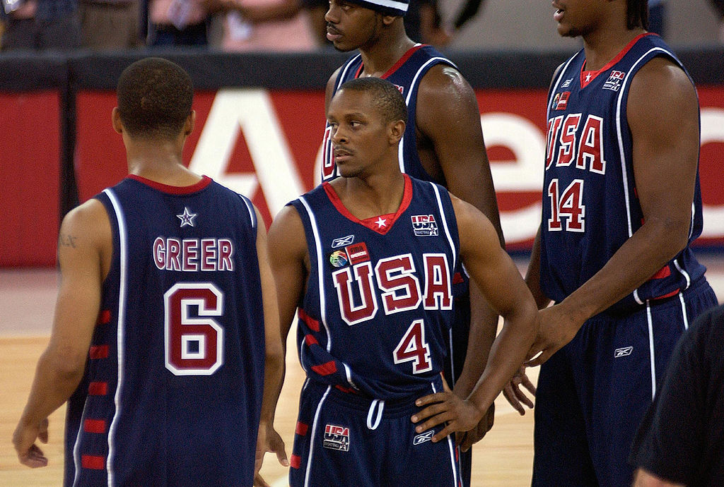 Tyus Edney (C) stands with teammates on the court