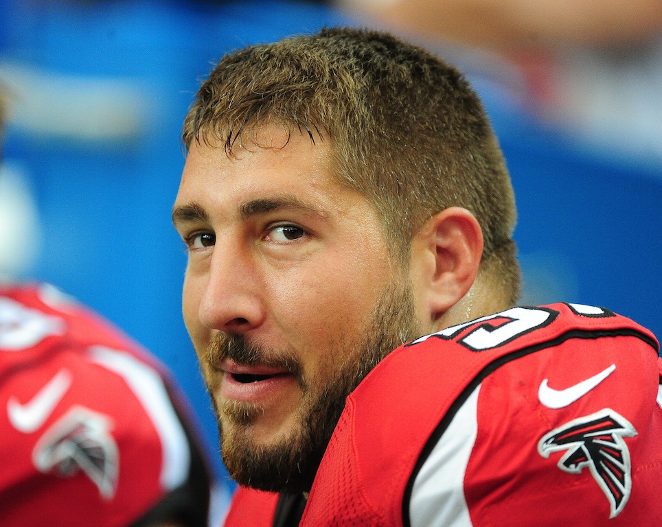 Alex Mack smiles as he sits on the bench.