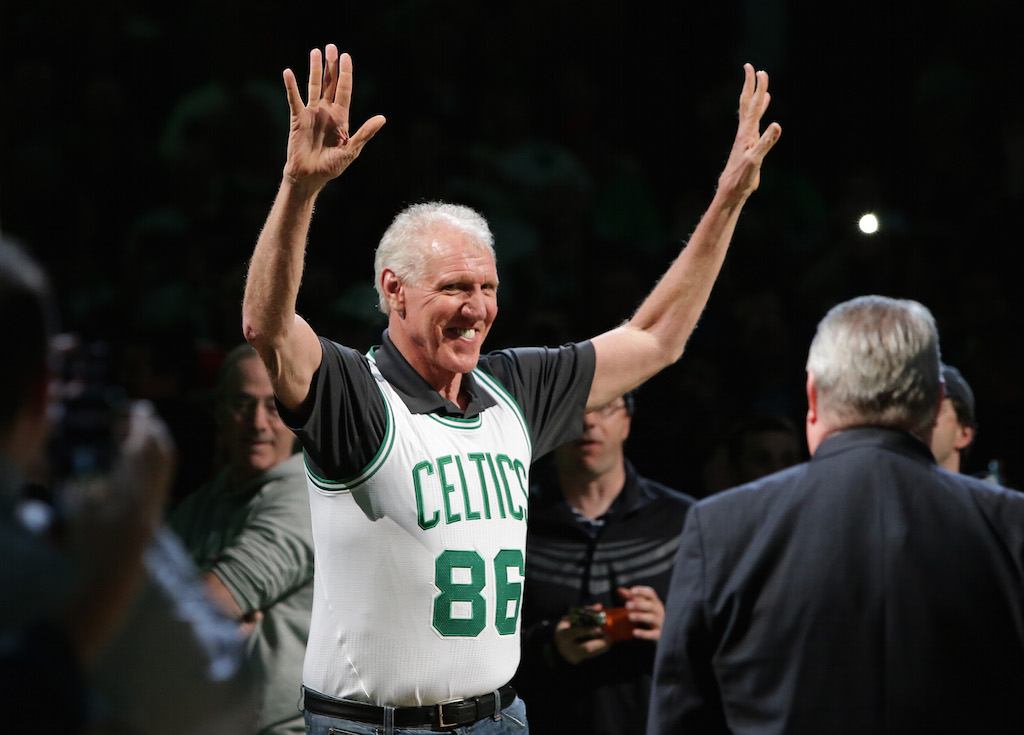Bill Walton waves to fans during a Celtics game.