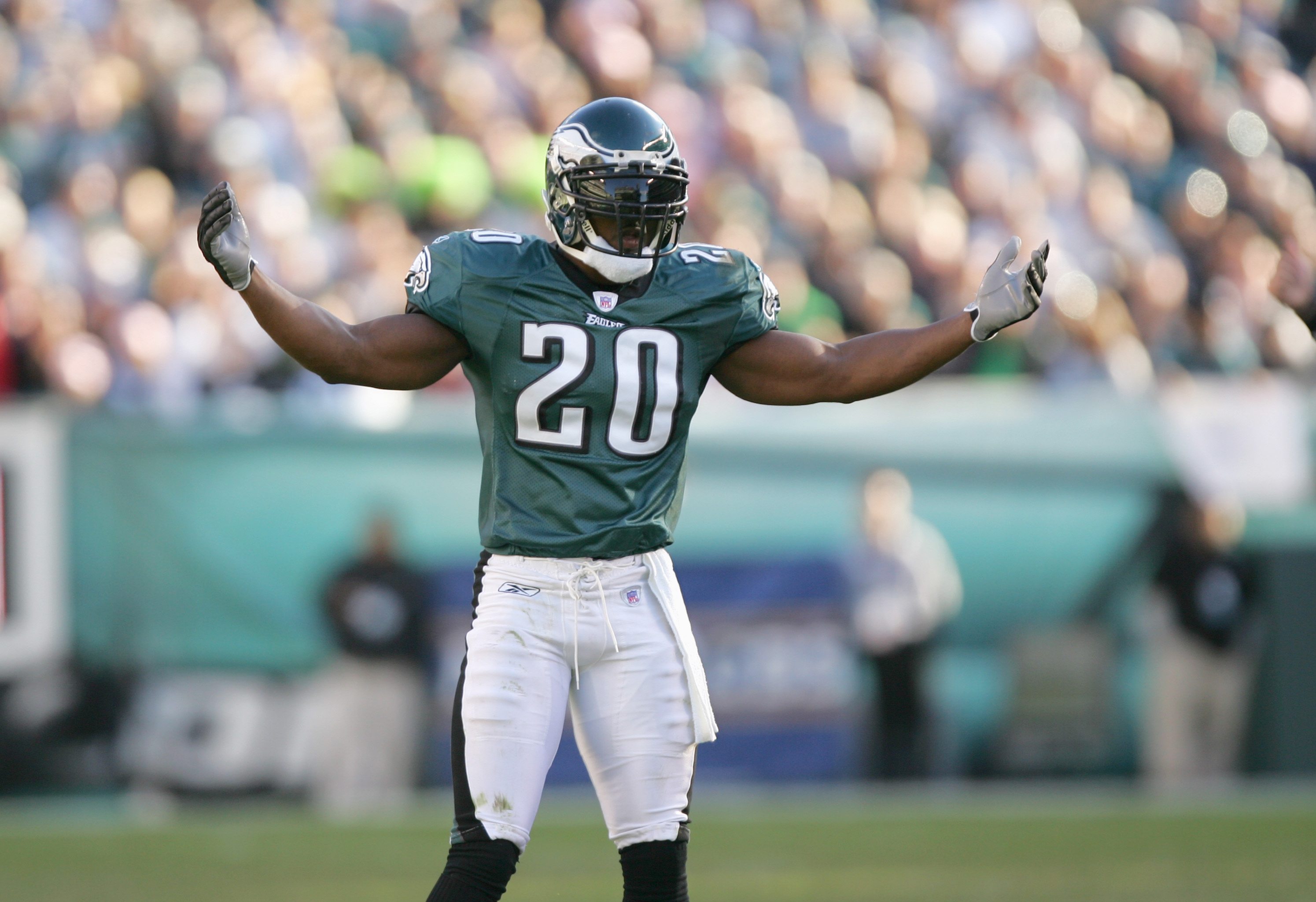 Brian Dawkins waves his arms at his teammate during warmups.