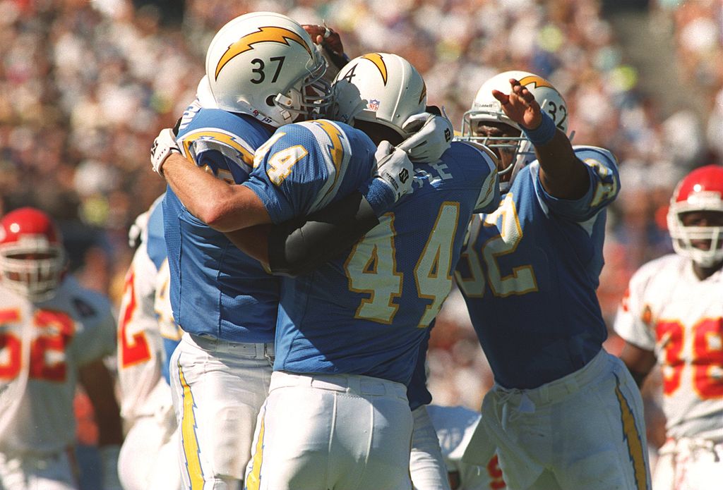 Members of the San Diego Chargers hug each other in celebration.