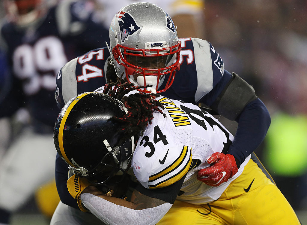 DeAngelo Williams of the Pittsburgh Steelers is tackled by Dont'a Hightower of the New England Patriots.