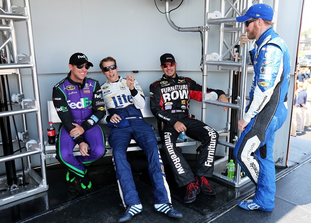 WATKINS GLEN, NY - AUGUST 09: (L-R) Denny Hamlin, driver of the #11 FedEx Ground Toyota, Brad Keselowski, driver of the #2 Miller Lite/Luke Bryan Ford, Martin Truex Jr., driver of the #78 Furniture Row/Visser Precision Chevrolet, and Dale Earnhardt Jr., driver of the #88 Nationwide Chevrolet, talk behind stage prior to the NASCAR Sprint Cup Series Cheez-It 355 at the Glen at Watkins Glen International on August 9, 2015 in Watkins Glen, New York.  (Photo by Jerry Markland/Getty Images)
