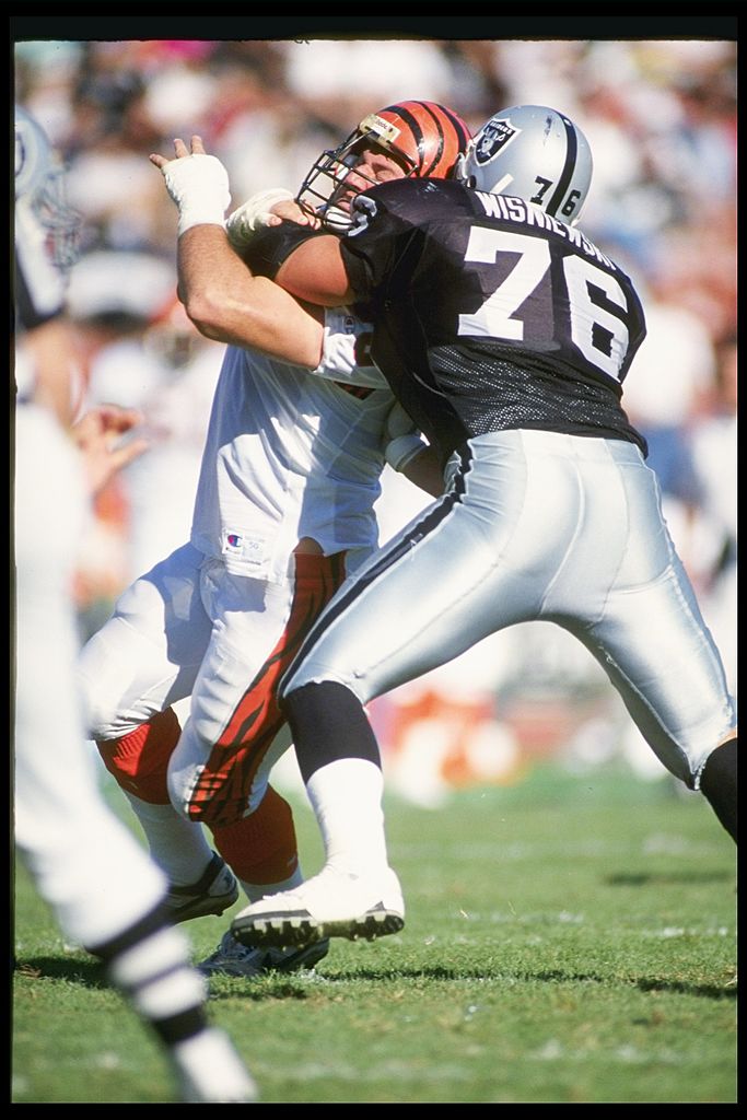 Offensive linemen Steve Wisniewski of the Los Angeles Raiders blocks defensive linemen Tim Krumrie of the Cincinnati Bengals.