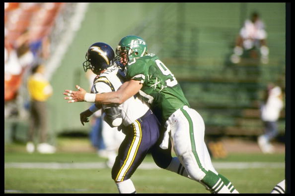 Defensive lineman Dennis Byrd of the New York Jets tackles San Diego Chargers quarterback Billy Joe Hobert.