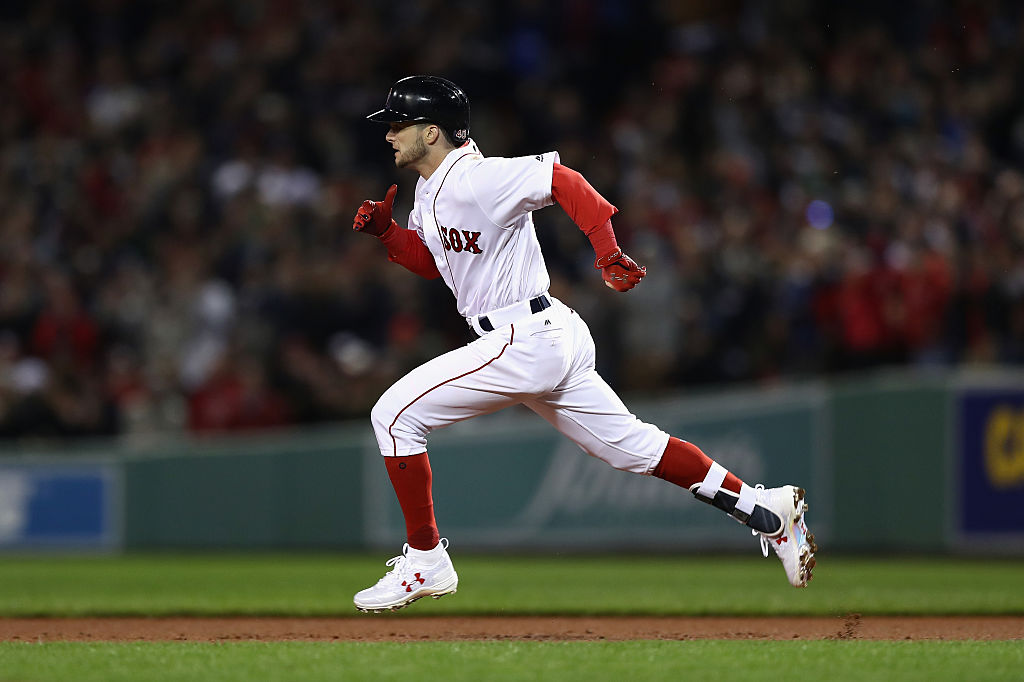 Andrew Benintendi of the Boston Red Sox runs after hitting an RBI double