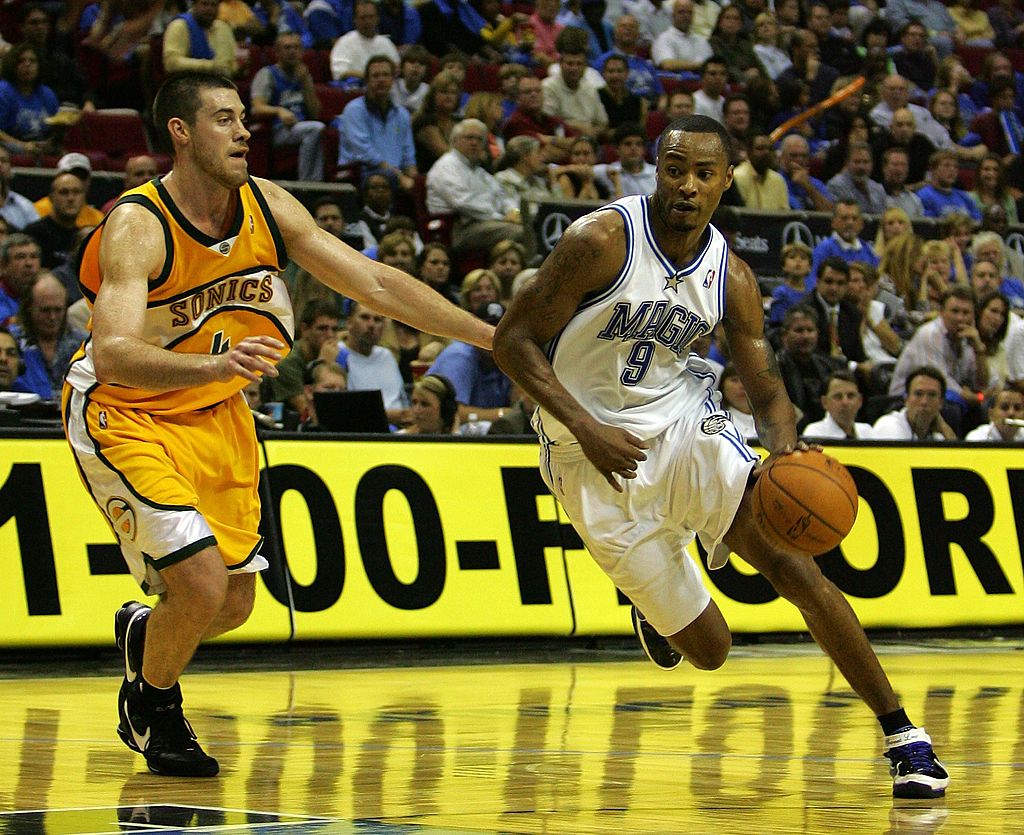 Rashard Lewis of the Orlando Magic drives past Nick Collison of the Seattle SuperSonics.